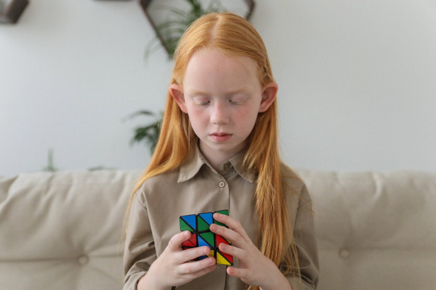 cute girl thinking over bright puzzle cube