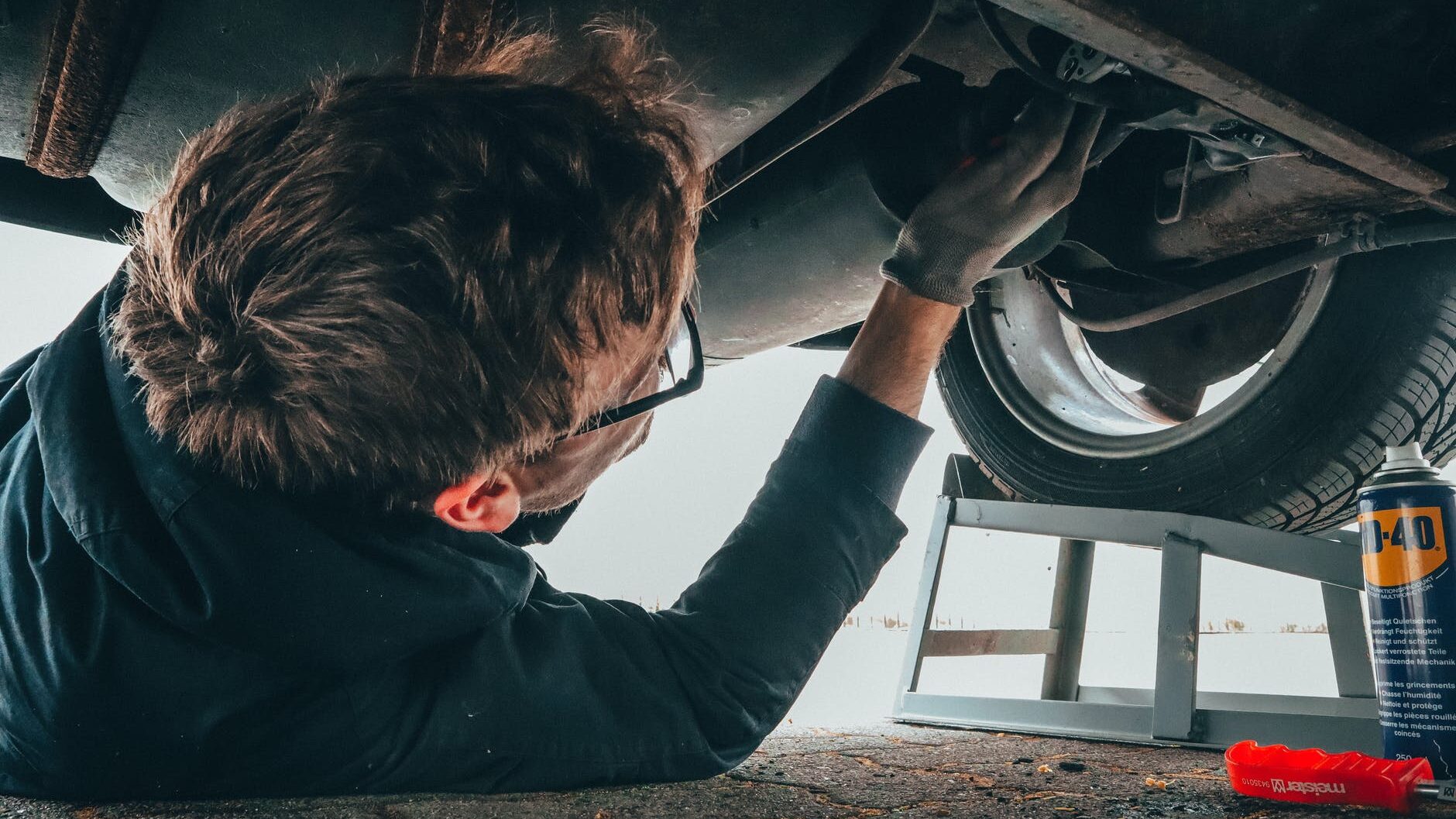 man fixing vehicle engine