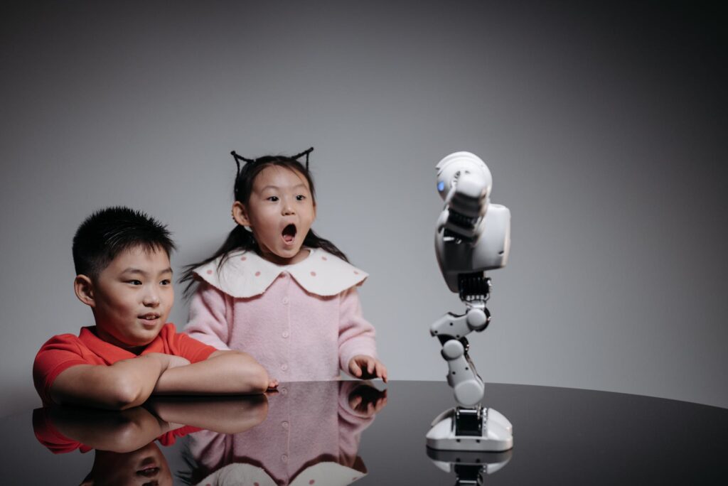 kids looking at white toy robot on the table