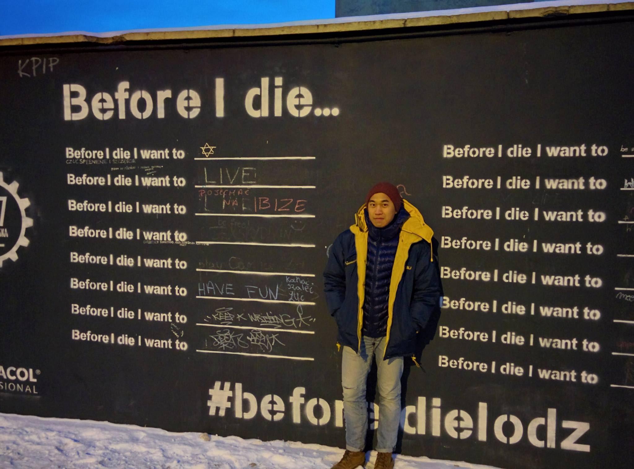 A person standing in front of a sign
Description automatically generated with medium confidence